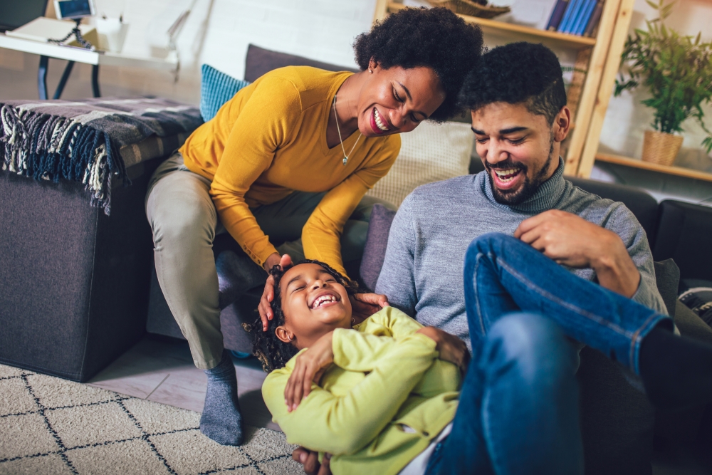 Happy african american family having fun at home.